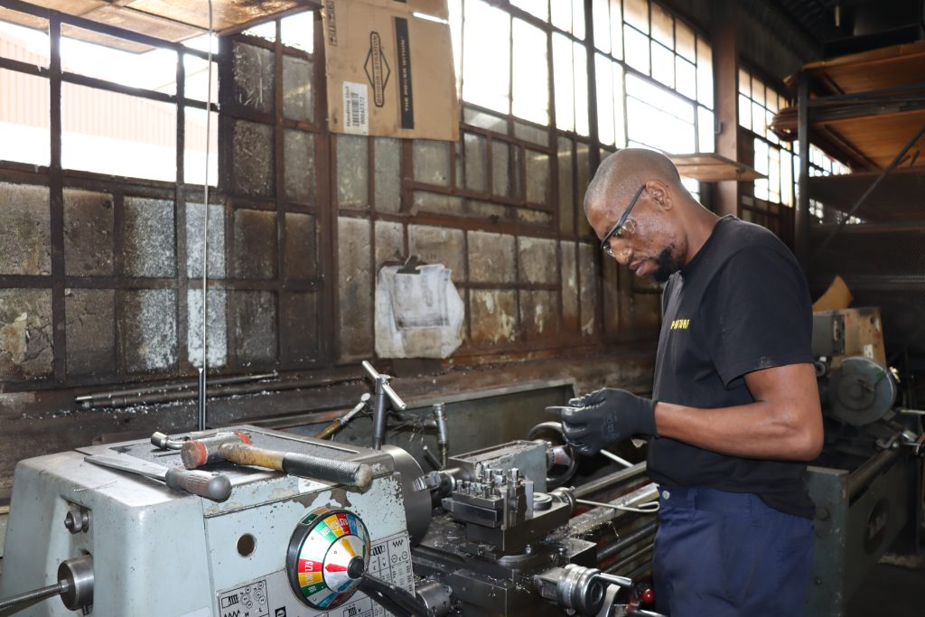 Slashing Fuel Costs: Smart Strategies for Efficient Turf Equipment 1 Worker operating a lathe machine.